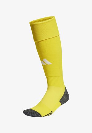 Gelbe Sportsocke mit strukturiertem Beinbereich, grauen Fersen- und Zehenakzenten sowie weißem Logodesign. Knielange Ausführung mit geripptem Bündchen.