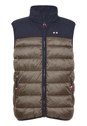 Pufotas liemenė su tamsiai mėlyna viršutine dalimi ir alyvuogių žalia apatine dalimi. Uždarymas paslėptu užtrauktuku, dvi šoninės kišenės ir logotipo akcentas ant krūtinės.