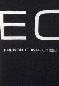 Black T-shirt featuring large white text that reads "EC" with "FRENCH CONNECTION" below in smaller letters. Cotton material with a smooth texture.