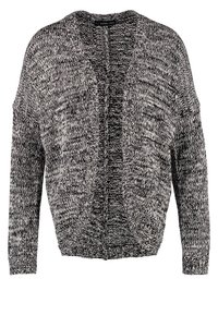 Cardigan texturé à devant ouvert en noir et blanc, présentant une coupe décontractée, des manches longues et un motif chiné subtil sur l'ensemble.