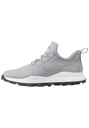 Light gray athletic sneaker with white sole, black tread, lace-up design, padded collar with orange lining, and pull tab at heel.