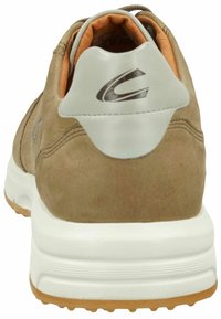 Brown suede sneaker with a white rubber sole, padded brown interior, and silver accent on the heel featuring a stylized logo.