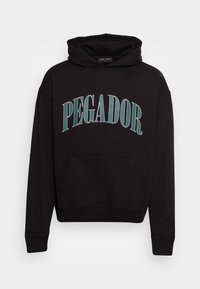 Felpa nera con cappuccio, tasca frontale, cordoncino e grafica curva "PEGADOR" in teal. Tessuto morbido con polsini e orlo a costine.