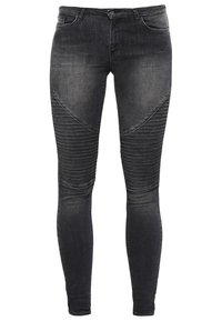 Jeans skinny de denim negro con textura acanalada en los muslos. Presenta un diseño clásico de cinco bolsillos y cierre frontal con botón.