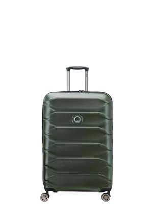 Hard-shell suitcase in dark green with a textured surface, featuring a retractable handle and four wheels for mobility. Circular logo on front.