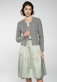 Grau gestrickte Strickjacke mit Rautenmuster, mit Rundhalsausschnitt und Knopfverschluss, über einem hellgrünen Satinkleid getragen.