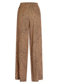 Wide-leg trousers in tan with black wavy pattern. Elastic waistband, two back pockets, smooth texture, and loose fit for comfort.