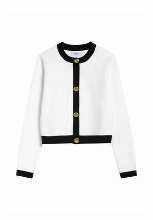 Biała dziergana kamizelka z czarnymi żeberkowymi wykończeniami i pięcioma złotymi guzikami z przodu. Ma długie rękawy i krótki krój.