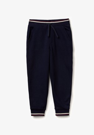 Pantalones de chándal azul marino hechos de una tela suave, con una cinturilla elástica con rayas rojas y blancas, dos bolsillos laterales y piernas ajustadas.