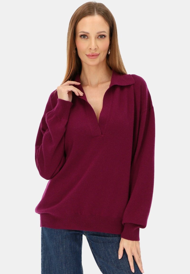Żywa bordowa bluza z kołnierzykiem, luźnym krojem i długimi rękawami, wykonana z miękkiego, teksturowanego materiału.
