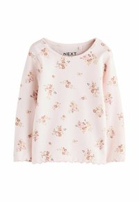 Maglietta a maniche lunghe di un rosa chiaro realizzata in tessuto a coste, con piccoli motivi floreali in rosa e marrone. Orlo ondulato e scollatura rotonda.