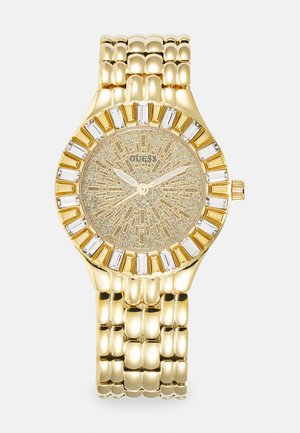 Goldfarbene Uhr mit strukturiertem Zifferblatt und geometrischen Akzenten. Das Armband hat ein verlinktes Design. Kristallverzierungen schmücken die Lünette.