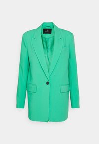 Blazer verde con revers a un bottone, chiusura a un bottone, due tasche frontali e texture liscia. Interno non foderato visibile.