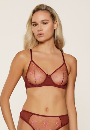 Bordeaux bh met doorzichtige mesh cups, geborduurde bloemenpatronen in het roze en verstelbare bandjes. Heeft een strikdetail in het midden.