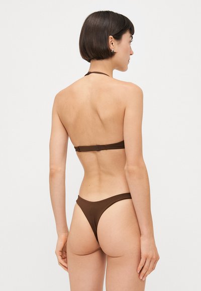 Brown bikini set featuring a halter neck and minimal coverage. Smooth fabric with a subtle sheen, adjustable back closure and side seams.