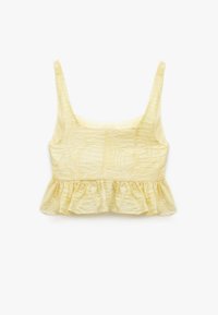 Gul crop top med breda axelremmar, texturerad tyg med ett löv mönster och en utställd nederkant. Mjuk finish och lätt design.