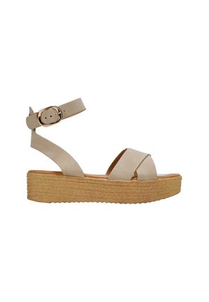 Sandali piattaforma beige con suola in juta stile espadrillas, design a cinturini incrociati e cinturino alla caviglia regolabile con dettagli in oro.