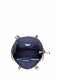 Otwarte beżowe torebka z ciemnoniebieską podszewką, jedną kieszenią na zamek i metką marki "JOOP! JEANS" wewnątrz.