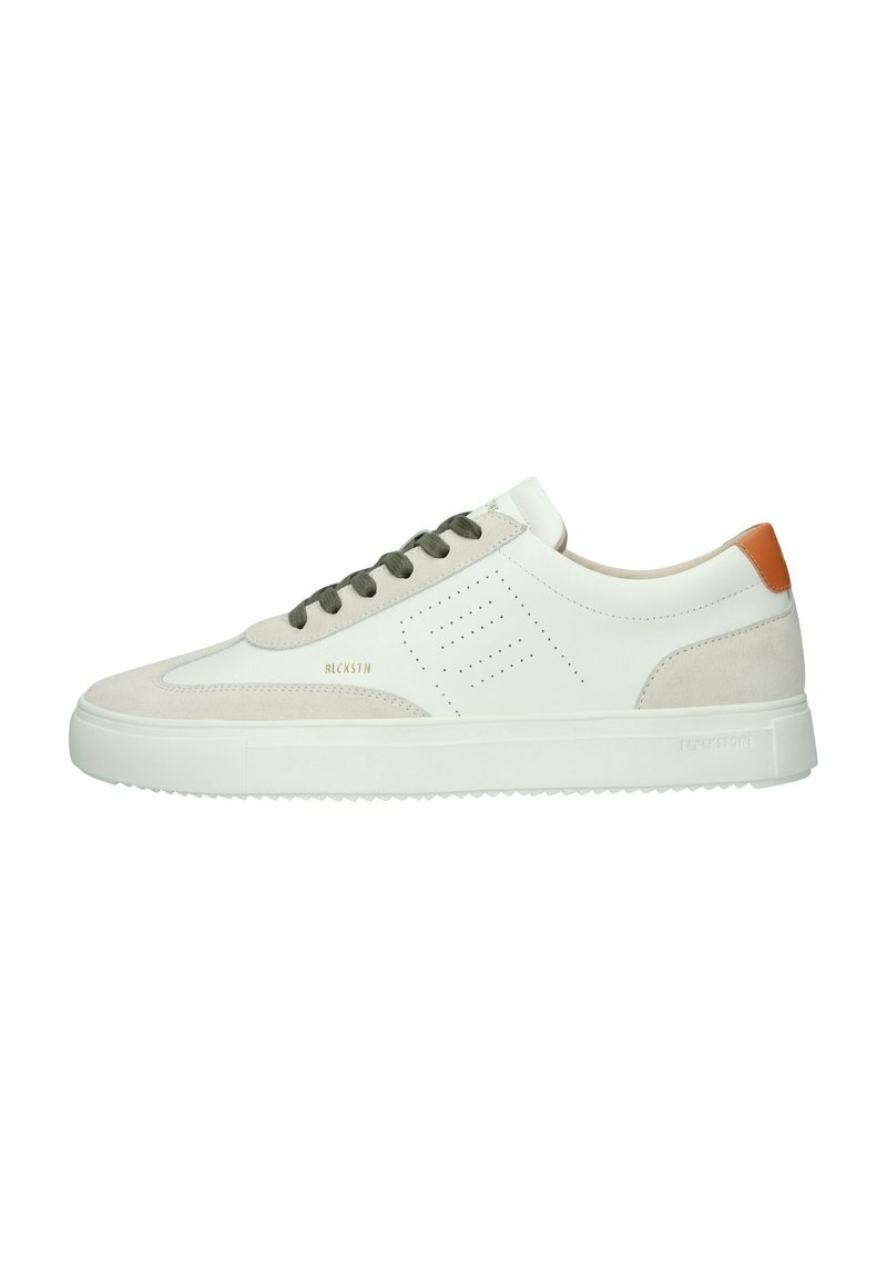 White leather and beige suede sneakers with olive green laces, a tan leather heel accent, and subtle perforated detailing on the side.