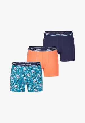 Drie paar boxershorts: één marineblauw, één oranje en één met een bloemenpatroon op een teal achtergrond. Alle hebben een zwarte tailleband met de tekst "HAPPY SHORTS."
