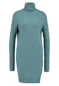 Maglione over-size turchese con dolcevita a coste, maniche lunghe e polsini e bordo a coste; realizzato in un morbido materiale testurizzato.