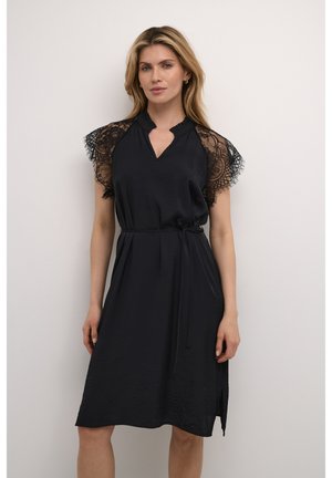 Black dress with lace short sleeves, V-shaped neckline, fitted waist with a tie, and a mid-length skirt featuring side slits.