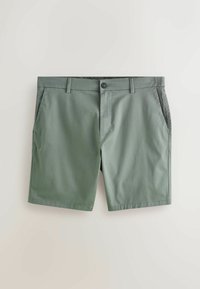 Shorts sur mesure pour homme en vert olive avec poches latérales, passants pour ceinture et fermeture à bouton sur le devant, posés à plat sur un fond clair.