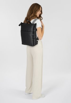 Zaino in pelle nera con spallacci decorati, forma rettangolare, due tasche esterne, superficie liscia e manico superiore per il trasporto.