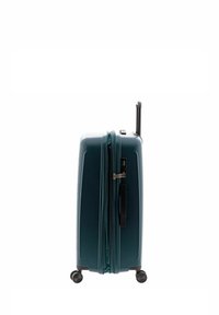 Valigia rigida di colore teal, dotata di scomparto con zip, manico retrattile e quattro ruote per la mobilità. Superficie liscia.