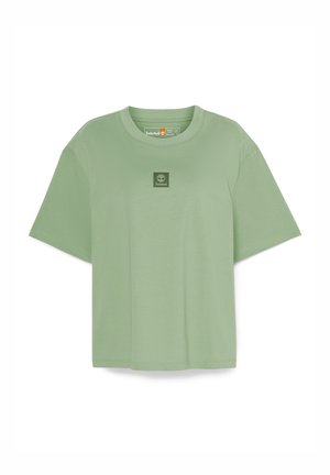 Green cotton t-shirt with short sleeves, round neckline, and a small square logo on the chest. Soft texture and loose fit design.