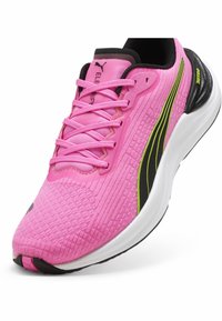 Roze sportschoen met een textiele bovenkant, zwarte accenten en groene strepen; beschikt over platte veters en een gevoerde zool.