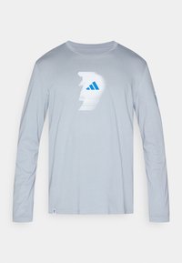 Light gray long-sleeve shirt made of soft fabric, featuring a white and blue graphic design on the front and a blue accent on the sleeve.