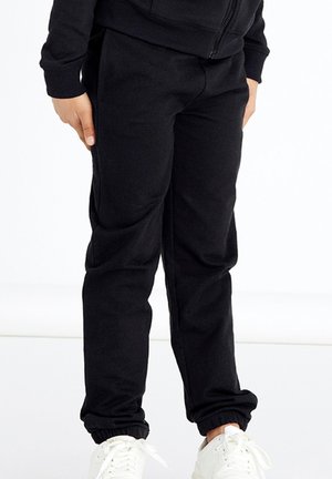 Black sweatpants with elastic cuffs and waistband, made of soft fabric. Side pockets with a relaxed fit and minimal seams for comfort.