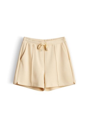 Beige cotton-blend shorts with elastic waistband, drawstring tie, side pockets, and front pleats, laid flat on white background.