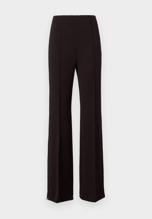 Melni augstās jostas bikses ar izlocītu kāju dizainu, kurām ir vertikālas šuves un šķēlumi apakšmalā, lai pievienotu papildu detaļas. Audums izskatās gluds.