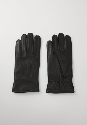 Par de guantes de cuero negro con detalles de costura, mostrando vistas frontal y trasera, dispuestos sobre un fondo gris.