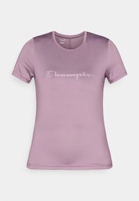 Λιλά κοντομάνικο T-shirt από απαλή ύφανση, με διακριτικό λογότυπο Champion σε τόνους πάνω στο στήθος και κλασική στρογγυλή λαιμόκοψη.