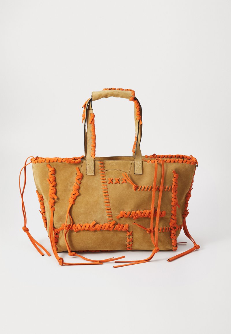 Geantă tote din suede bej cu accente din material portocaliu. Prezintă un design împletit, două mânere rezistente și panglici lungi. Suprafața texturată adaugă profunzime.