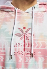 Hooded sweatshirt with a pink, white, and green pattern. Features a palm tree graphic, brand name, and metallic accents on the drawstrings.