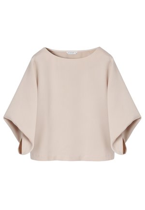 Beige loose-fit blouse with wide half sleeves and round neckline, made of smooth fabric, shown on a white background.