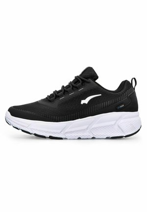 Black athletic shoe with a textured upper, featuring a white logo, thick white midsole, and rubber sole with a diamond pattern.
