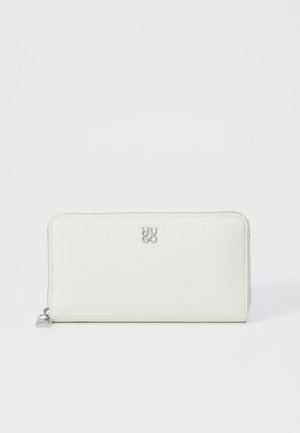 White leather zip wallet with textured surface, HUGO logo in silver at the front, and stitched detailing along the edges.