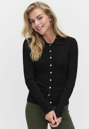 Cardigan noir à côtes avec manches longues, devant boutonné et col pointu. Comprend des boutons d'accent verts pour une touche supplémentaire.