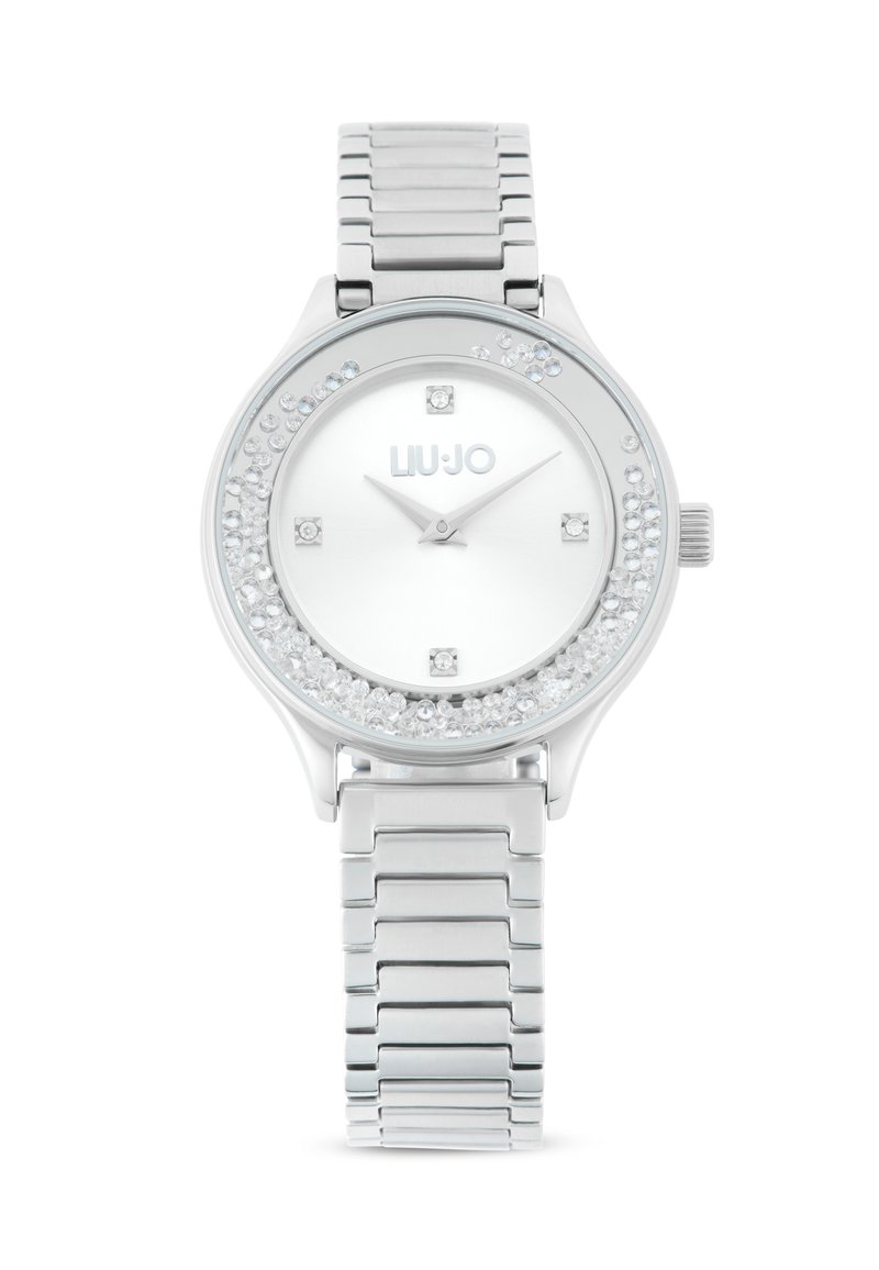 Sølv rustfrit stål ur med en krystalbesat bezel, hvid urskive og sølvfarvede time- og minutvisere. Har et kædet armbånd.