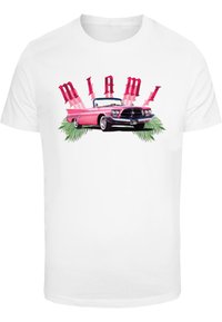 White t-shirt featuring a vintage pink convertible car, "MIAMI" in bold red letters, and green palm leaves as decorative accents.