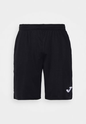 Sorte atletikshorts med elastisk talje og lille hvid logo på nederste højre ben mod ensfarvet baggrund.