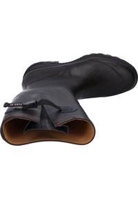 Bottes en caoutchouc marron foncé au design épuré, avec une Large ouverture et une semelle texturée. Intérieur doublé d'un matériau de couleur plus claire. Détail de sangle ajustable.