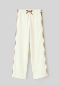 Pantalons larges de couleur crème avec taille élastique, cordon de serrage brun et rayures latérales brunes, fabriqués en tissu doux.