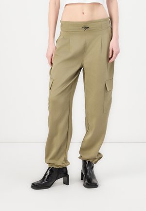 Olive green cargo pants with a drawstring waist, two side pockets, and tapered cuffs. Smooth fabric with a slightly shiny finish.