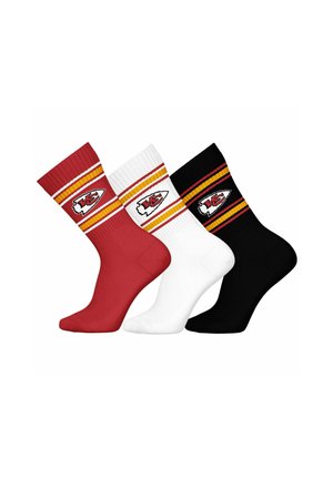 Three pairs of crew socks in red, white, and black, featuring ribbed tops, yellow and red stripes, and a logo patch on each sock.
